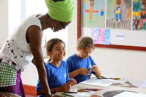Students in jewelry making class at Codrington School in Barbados